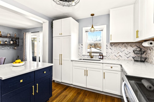 kitchen with stainless steel appliances, a kitchen island, light stone counters, and decorative light fixtures