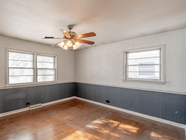 empty room featuring hardwood / wood-style flooring and ceiling fan