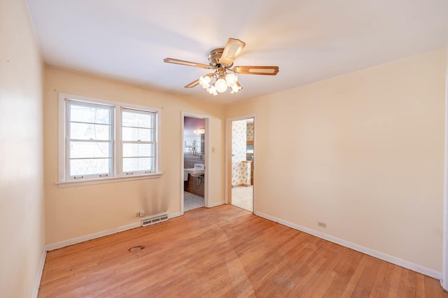 spare room featuring ceiling fan and light hardwood / wood-style floors