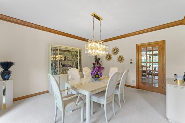 carpeted dining area featuring ornamental molding