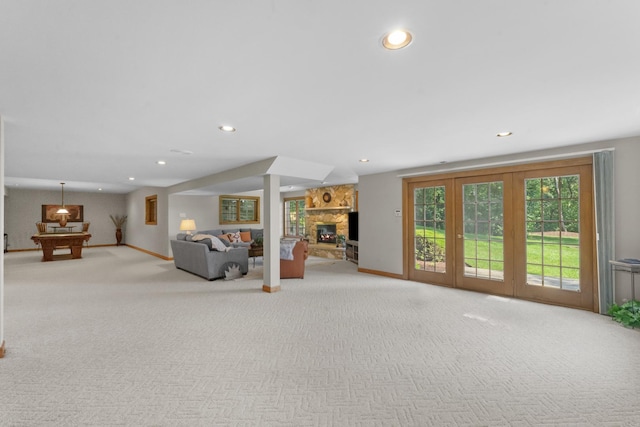 unfurnished living room featuring a fireplace, light colored carpet, and billiards