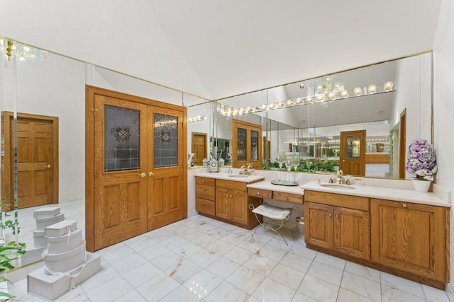 bathroom featuring vanity and high vaulted ceiling