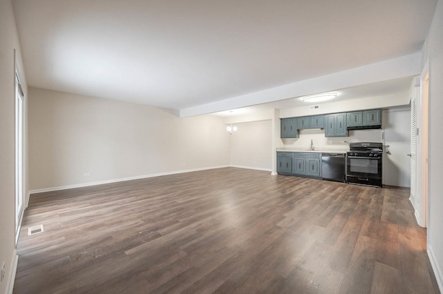 unfurnished living room with dark hardwood / wood-style flooring, an inviting chandelier, and sink