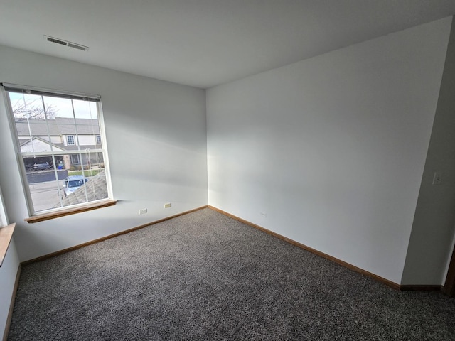 empty room with dark colored carpet