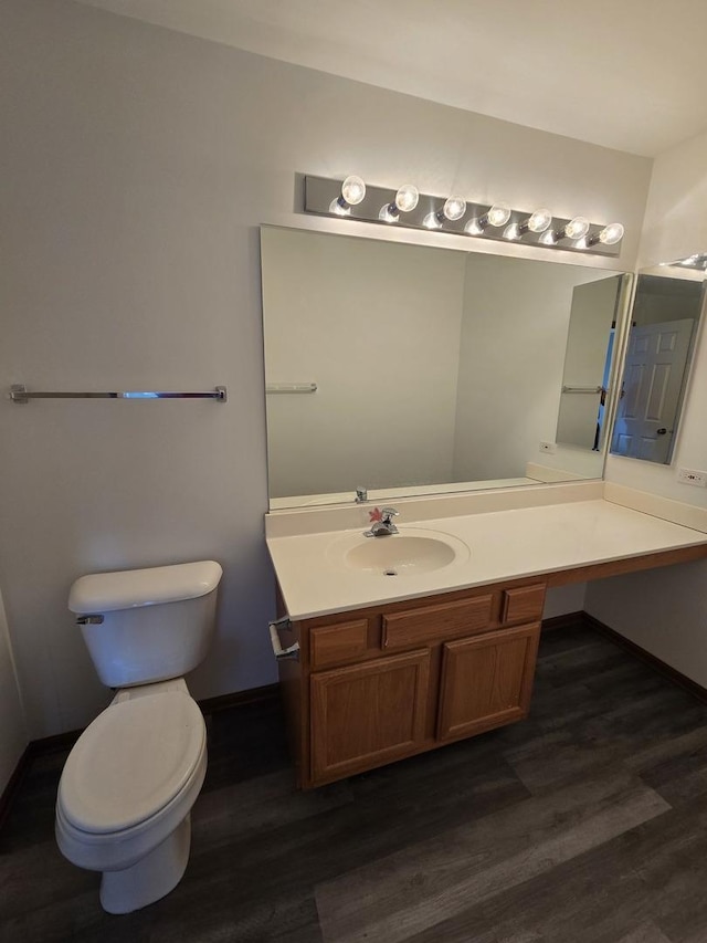 bathroom with hardwood / wood-style floors, vanity, and toilet