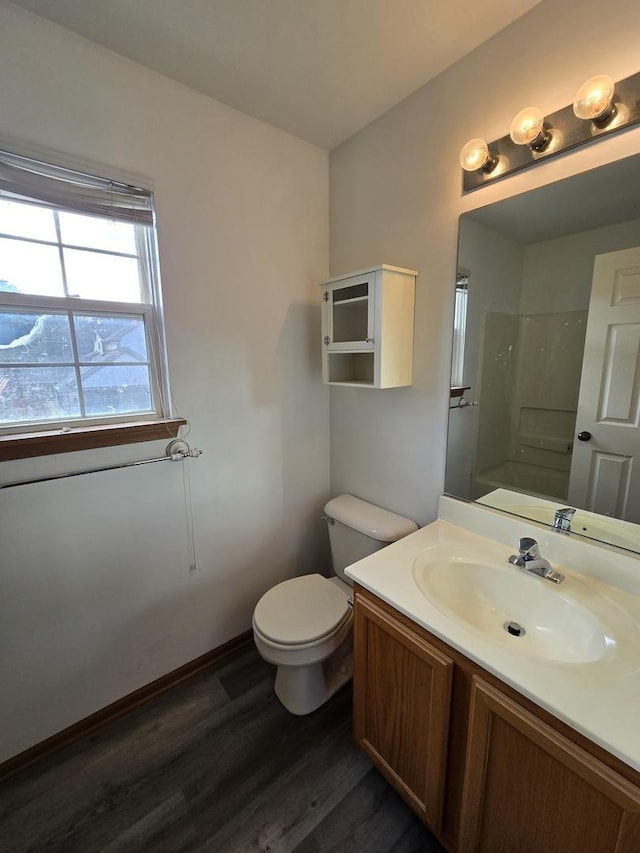 bathroom with a shower, wood-type flooring, vanity, and toilet