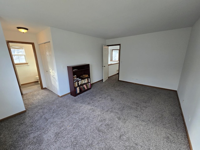 unfurnished living room featuring carpet