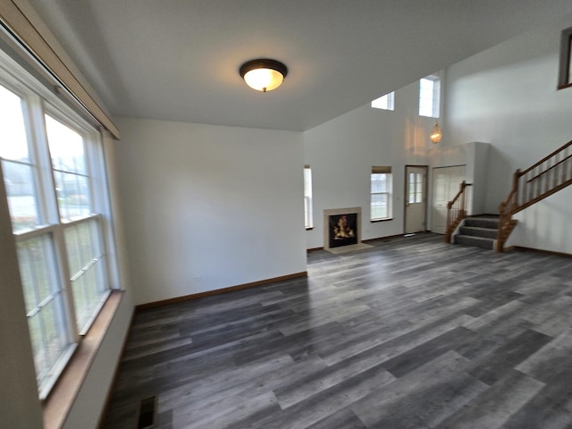 unfurnished living room featuring dark hardwood / wood-style floors