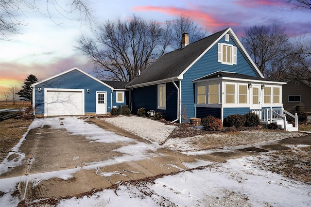 view of front facade featuring a garage and a sunroom