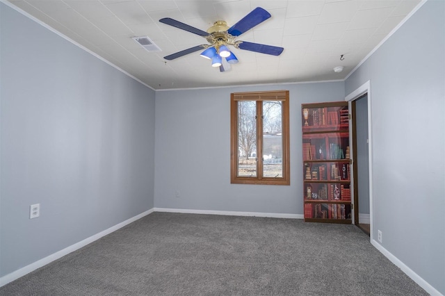 carpeted spare room featuring ornamental molding and ceiling fan