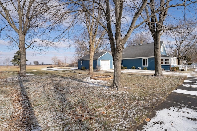 view of front of house featuring a garage and an outdoor structure