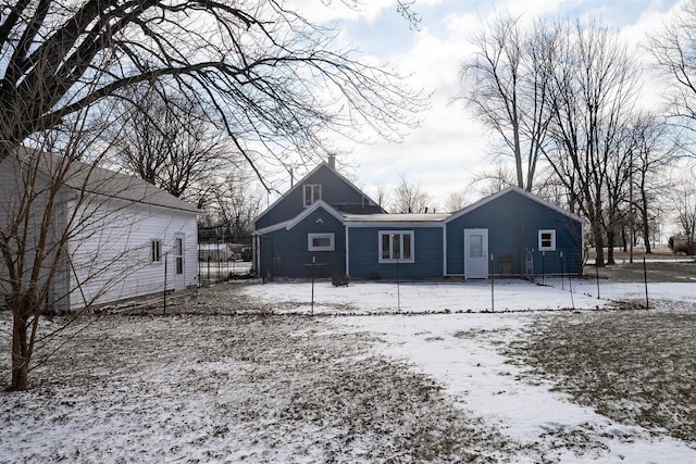 view of snow covered back of property