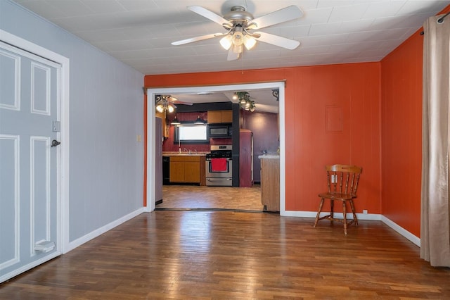 interior space featuring ceiling fan and dark hardwood / wood-style floors