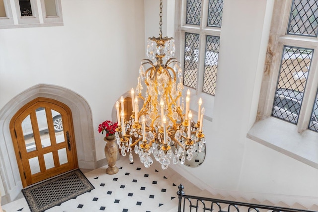 entrance foyer with tile patterned floors and an inviting chandelier