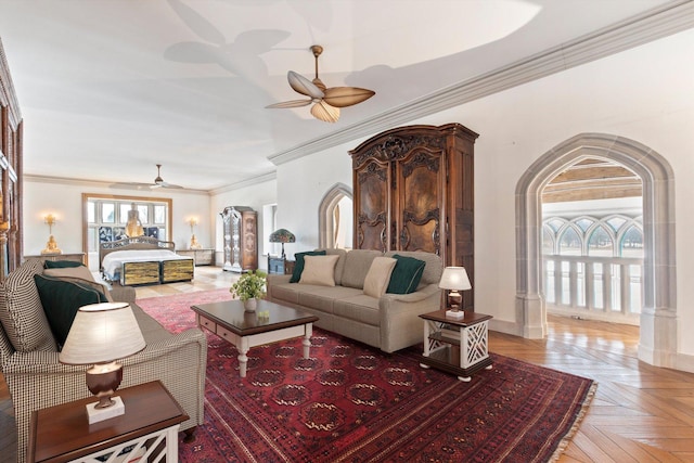 living room with light parquet flooring, plenty of natural light, crown molding, and ceiling fan