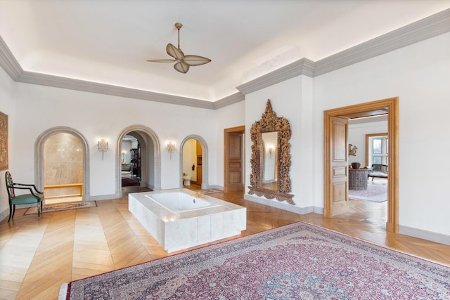 bathroom with ceiling fan, a bath, parquet flooring, and crown molding