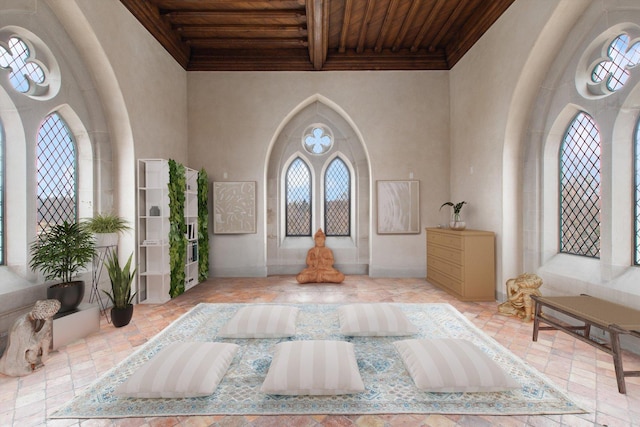 entryway featuring a towering ceiling, beamed ceiling, and wooden ceiling