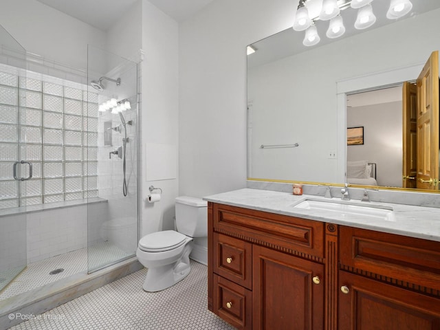 bathroom with vanity, toilet, tile patterned floors, and walk in shower