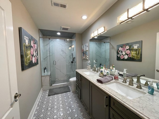 bathroom with vanity, a shower with shower door, and toilet