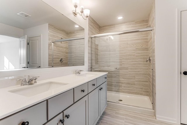 bathroom featuring vanity and a shower with shower door