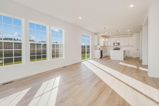 unfurnished living room with light hardwood / wood-style flooring