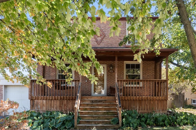 view of front of house featuring covered porch and a garage