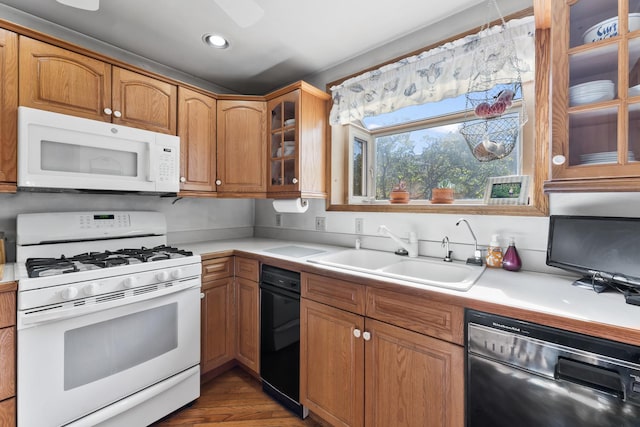 kitchen featuring sink, dark hardwood / wood-style floors, and white appliances