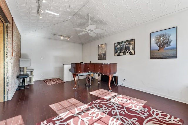 misc room featuring ceiling fan, dark wood-type flooring, and track lighting