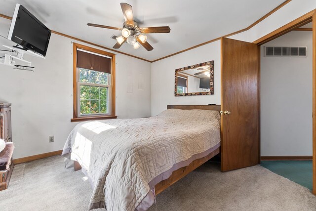 bedroom with carpet flooring, ceiling fan, and crown molding