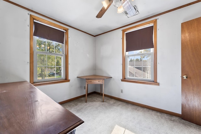 unfurnished office featuring ceiling fan, carpet floors, and crown molding