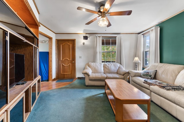 living room with carpet, ceiling fan, and crown molding