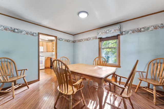 dining area featuring ornamental molding and light wood-type flooring