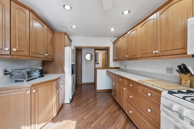 kitchen featuring wood-type flooring and white appliances