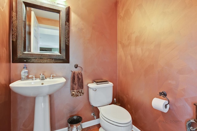 bathroom featuring toilet and sink