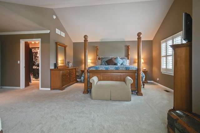 carpeted bedroom featuring a walk in closet, vaulted ceiling, and a closet