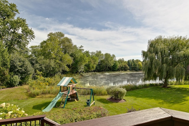 view of play area featuring a lawn and a water view