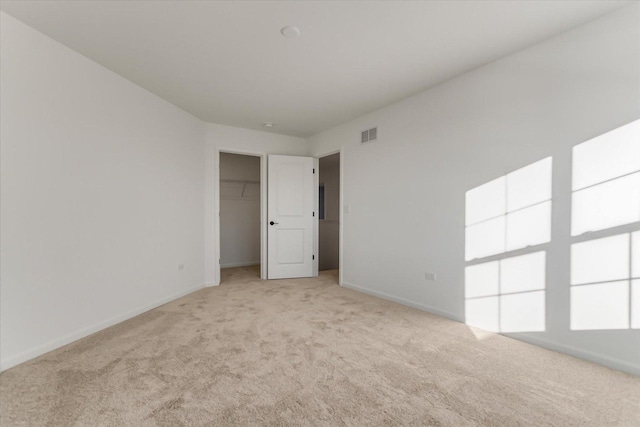 unfurnished room featuring light carpet