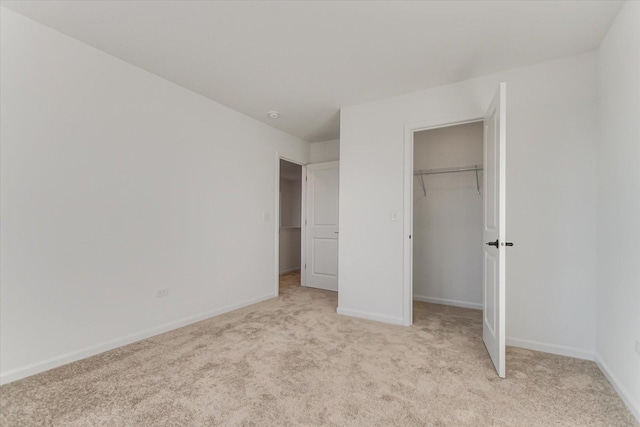 unfurnished bedroom featuring light carpet