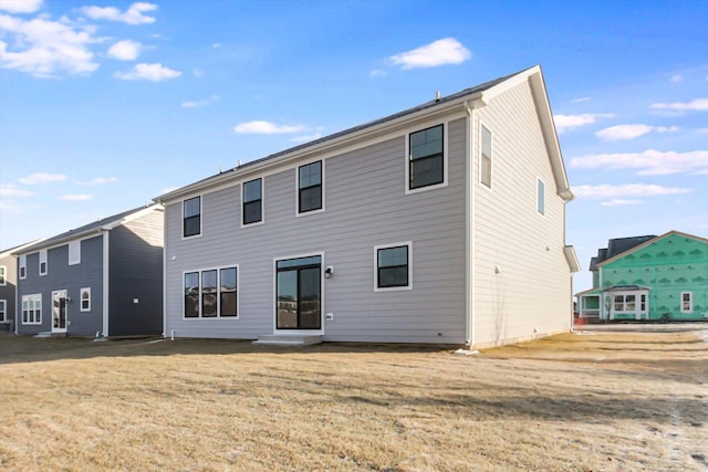 rear view of house with a yard