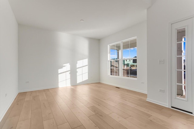 spare room with light hardwood / wood-style floors