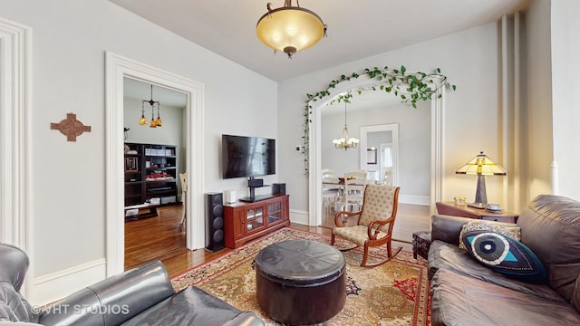 living room featuring hardwood / wood-style flooring and a chandelier