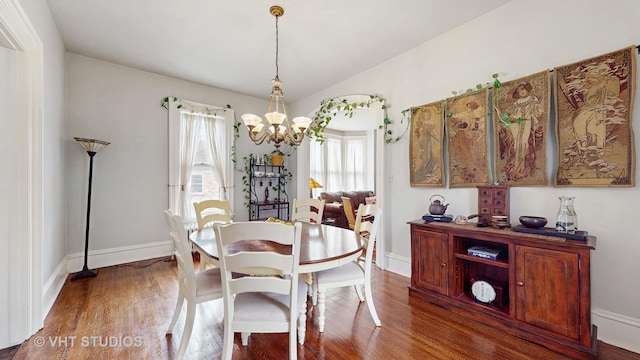 dining room featuring dark wood-type flooring and a chandelier