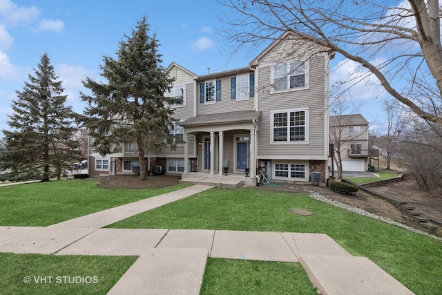 view of front of house with central AC, covered porch, and a front yard