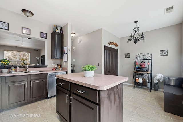 kitchen with a center island, an inviting chandelier, sink, stainless steel dishwasher, and dark brown cabinetry