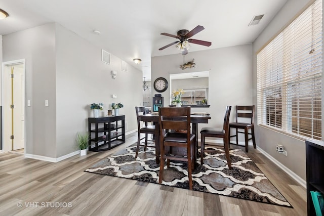 dining area with hardwood / wood-style flooring and ceiling fan