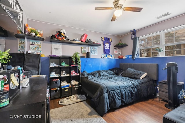 bedroom featuring hardwood / wood-style flooring and ceiling fan