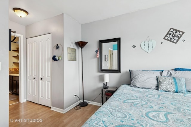 bedroom with a closet and hardwood / wood-style flooring