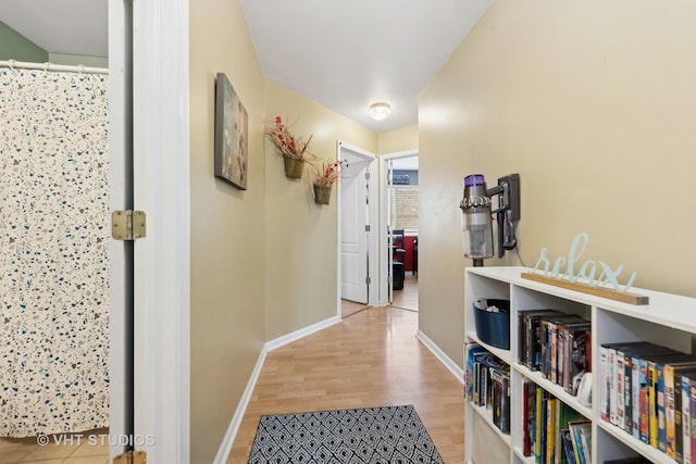 hallway with light hardwood / wood-style flooring