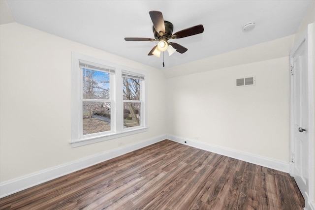 spare room with ceiling fan, dark hardwood / wood-style floors, and lofted ceiling