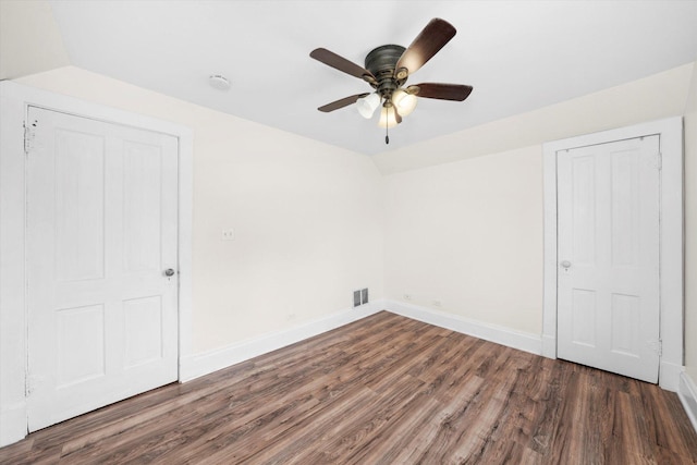 unfurnished bedroom featuring a closet, dark hardwood / wood-style floors, ceiling fan, and lofted ceiling